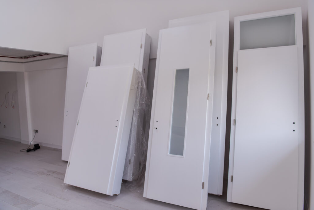 Interior doors stacked in a new apartment waiting for installation